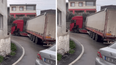 Kaygan yolda geri geri kayarak körüğü kitlenen bir tır, trafiği